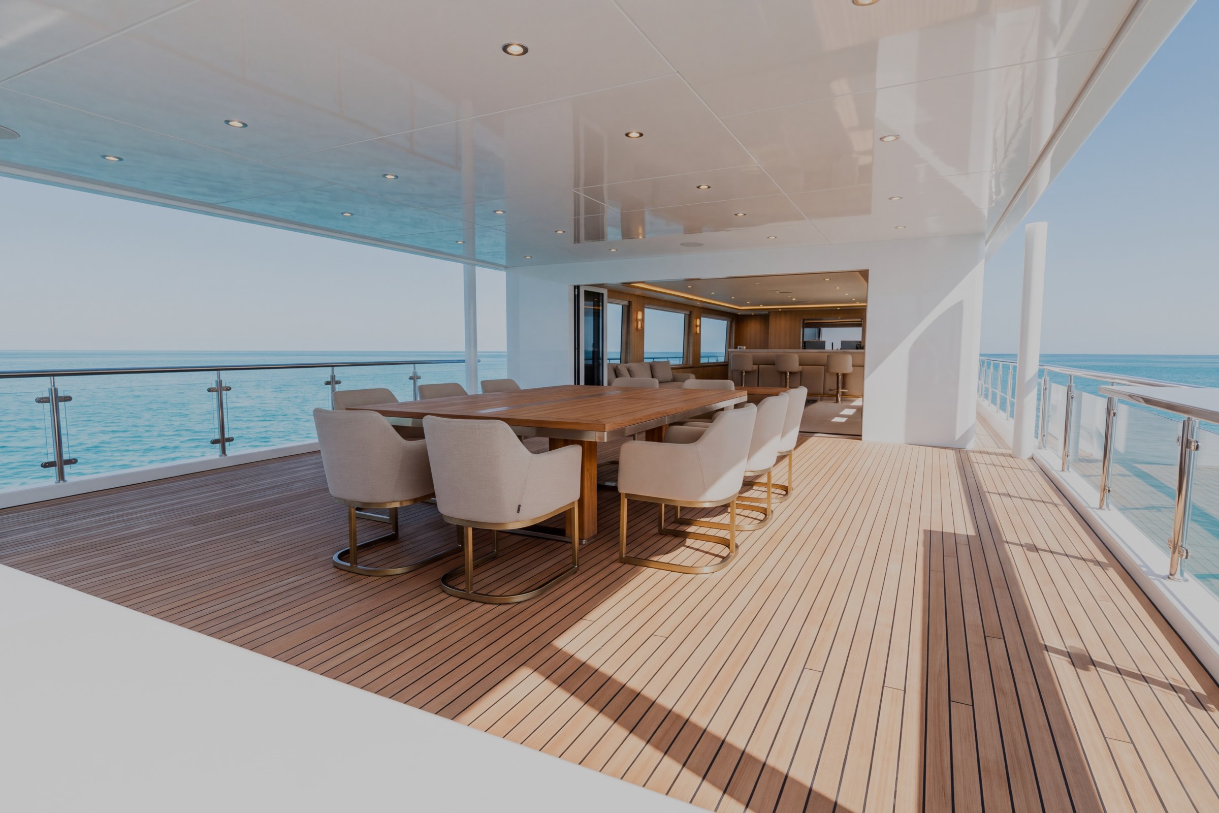 Upper aft terrace of the sample yacht with covered outdoor seating