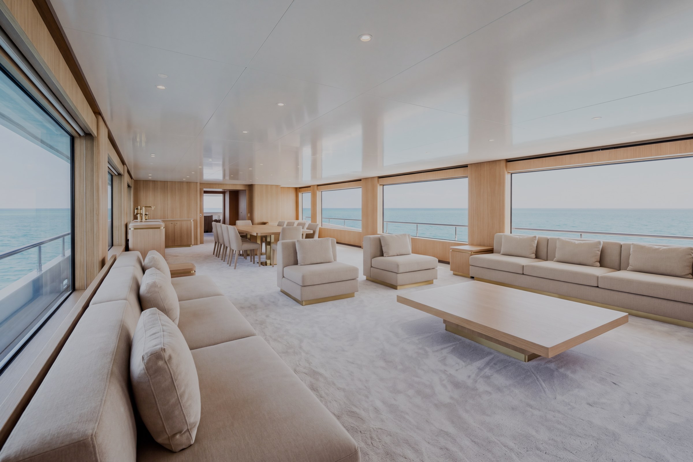 Main salon of the sample yacht with lounge seating and broad windows