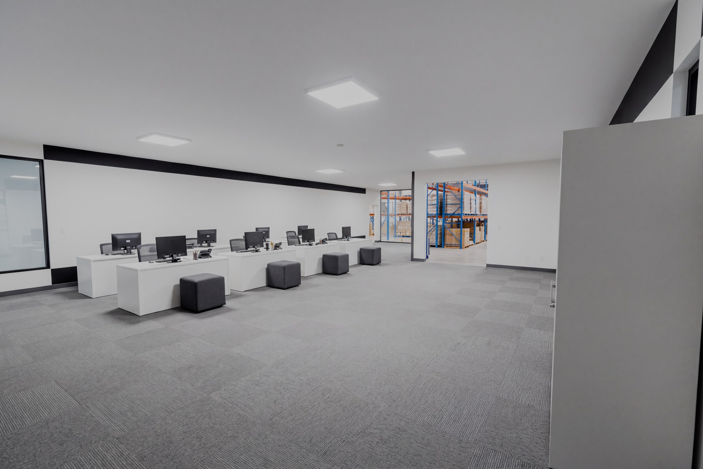 Open upper office in the sample warehouse, with desks and glass meeting rooms