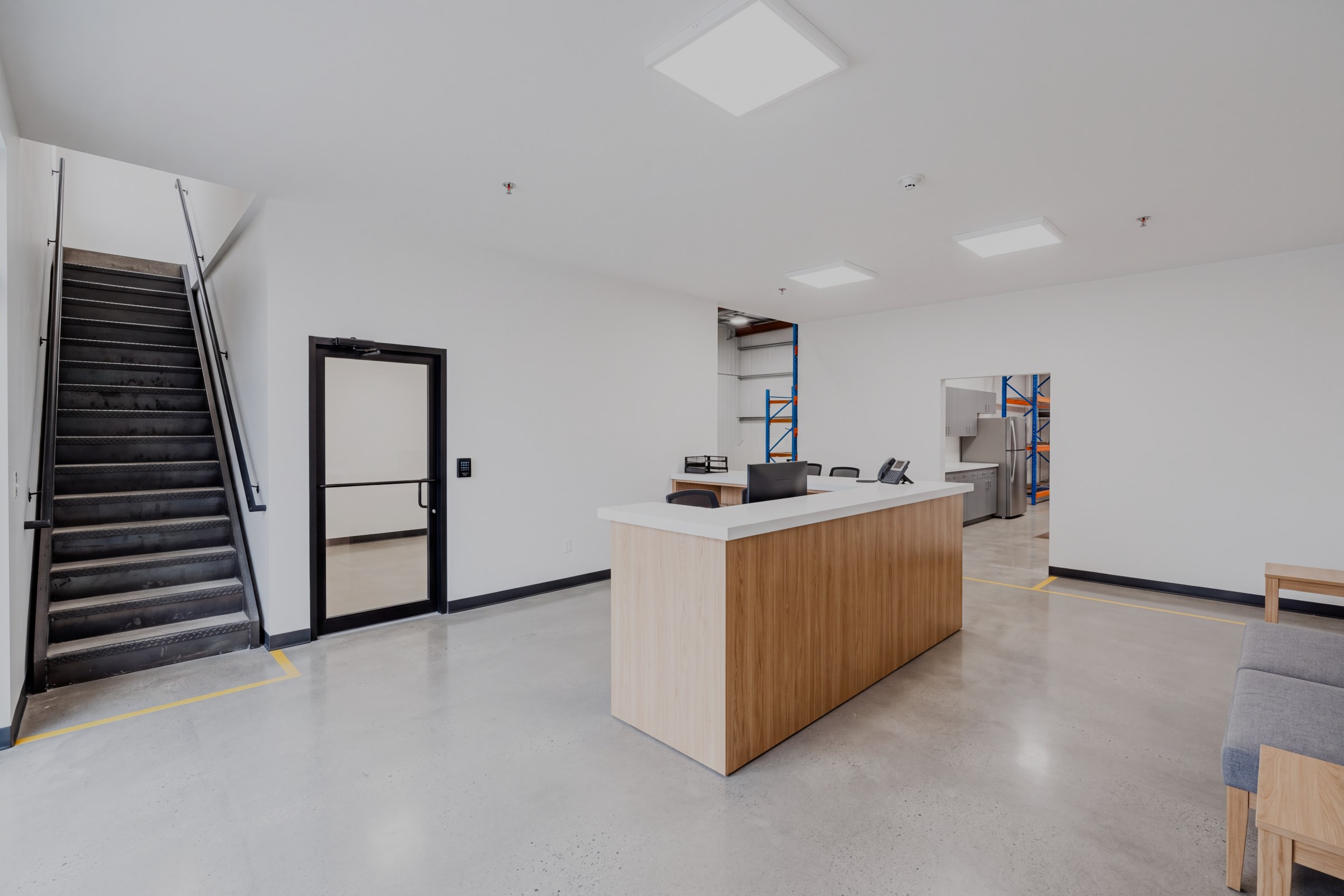 Reception area of the sample warehouse office, with wood counters and glass frontage